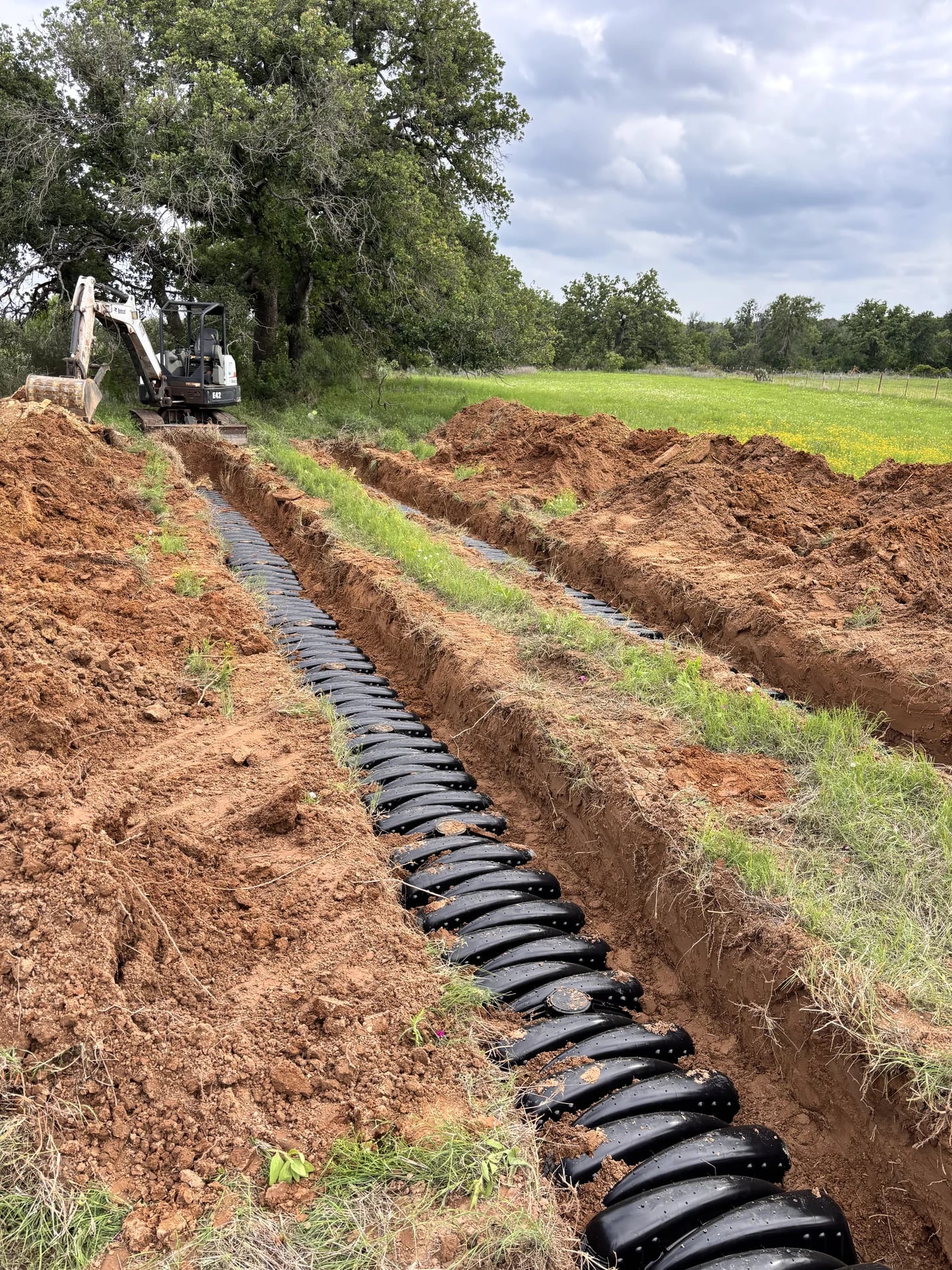 Long row of drainfield chambers placed in an open trench
