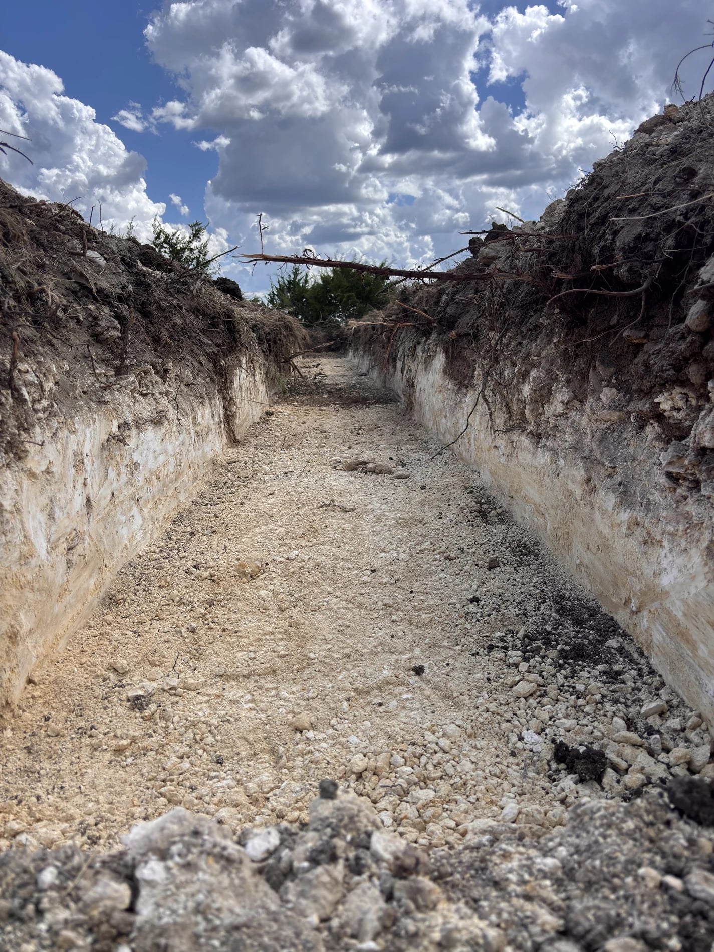 Open trench being prepared for a septic drainfield