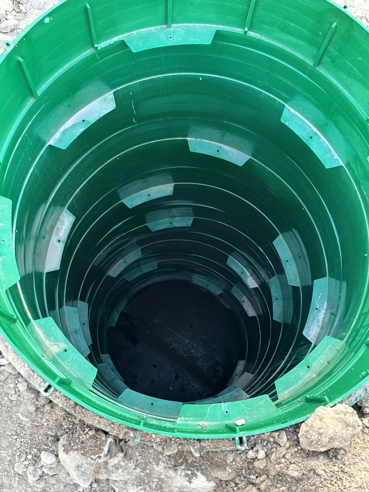 View into a green septic tank access riser